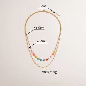 Detailed view of layered gold necklace showing 41.5cm and 45cm chain lengths with heart charms