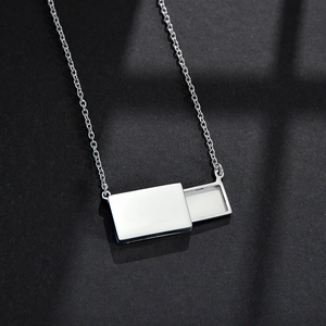 Minimalist stainless steel pull-out envelope necklace with sliding pendant on black surface