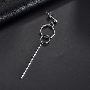 Minimalist silver geometric long cylinder earrings with interlocking rings on black leather