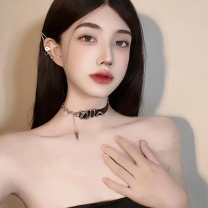 Punk choker necklace featuring silver chains and green crystal cone pendant on model