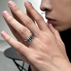 Unisex silver stainless steel ring with industrial geometric hollow design on finger