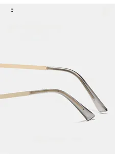 Detail of curved gold metal temples with translucent grey tips for ergonomic comfort