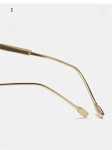 Detail view of light gold metal curved mirror legs for comfortable wear and ergonomics