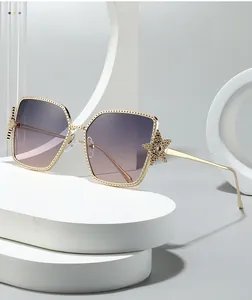 Close-up of gold metal sunglasses frame with star detail and gradient purple lens