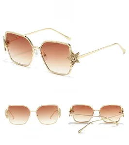 Detail view of gold metal star frame sunglasses with brown gradient lenses from three angles