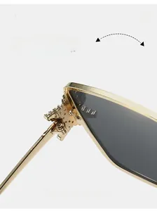 Detail of durable gold metal hinges with intricate relief patterns on star sunglasses
