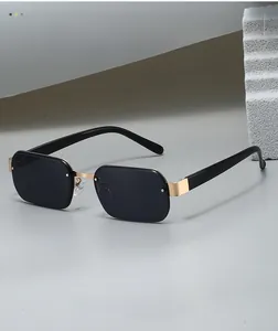 Detail view of the black rectangular lens and gold metal bridge of these trendy sunglasses