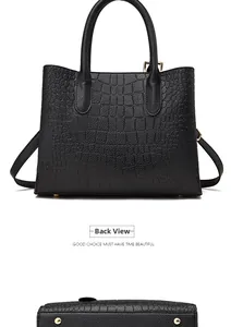 Detailed back view and bottom studs of black embossed crocodile pattern leather tote bag