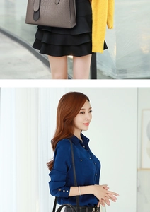Close-up of grey crocodile embossed handbag paired with a yellow cardigan and layered skirt