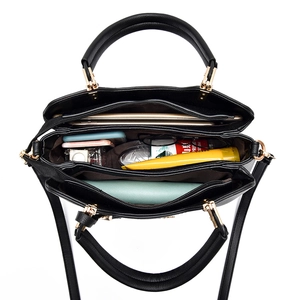 Internal view showing multiple compartments and large capacity of this black tote bag
