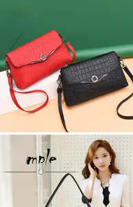 Detail showing red and black crossbody bags with embossed crocodile texture and metal ring