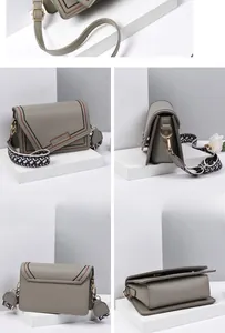 Detail view of grey-green crossbody bag with color-contrast stitching and geometric strap