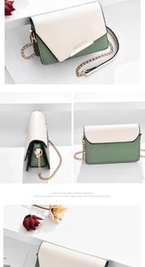 Détail du petit sac à bandoulière bicolore avec barre en métal et bandoulière en chaîne
