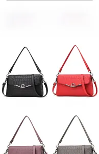 Detail of elegant crocodile textured flap handbags in black, red, purple, and grey colors