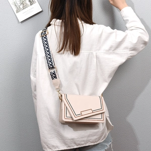 Chic cream PU leather crossbody bag featuring contrast stitching and geometric strap