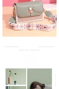 Detail of crossbody bag with cat metal lock and wide snowflake patterned strap