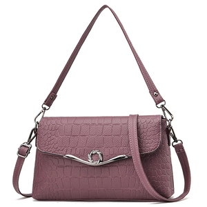 Elegant crocodile embossed shoulder bag in dusty pink with silver metal buckle