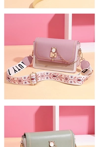Detail of macaron crossbody bag featuring a golden cat clasp and embroidered wide strap