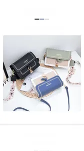 Close-up of PU leather crossbody bags with colorful stitching and printed woven straps