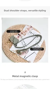 Detail of white lychee leather bag with colorful wide strap and gold magnetic buckle