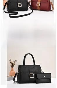 Detail of stone textured leather tote set with gold buckle and matching envelope pouch