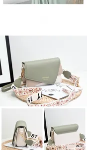 Detail of green and beige crossbody bag with wide patterned jacquard shoulder strap