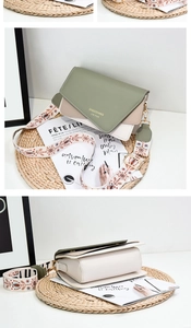 Detail of color-block flap bag with a wide ethnic style woven shoulder strap and metal buckle