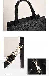 Detail of black faux crocodile texture, golden hardware hooks, and smooth metal zipper