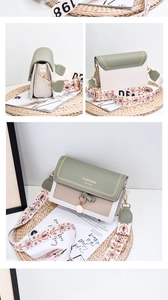 Detail of contrast stitching and vintage embroidered strap on a chic crossbody bag