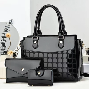 Three-piece black patent leather tote bag set with grid embossing and gold hardware