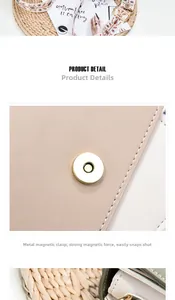 Detail of metal magnetic buckle on beige leather crossbody bag with embroidered strap