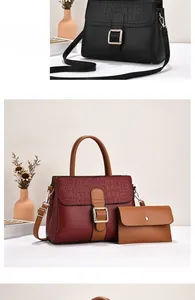 Detail of stone textured leather handbag with gold buckle and matching clutch pouch