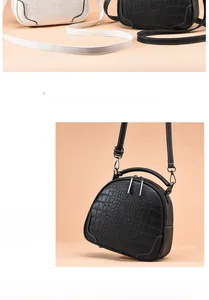 Detail of crocodile pattern leather handbags showing dual zippers and sturdy handles