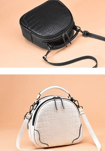 Close-up of semi-circular shell bags featuring premium faux crocodile embossed texture