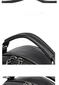 Detail of crocodile pattern bag showing sturdy handle and dual silver metal zippers