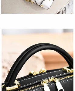 Dettaglio borse a spalla vintage con zip dorate e cuciture a contrasto bianche
