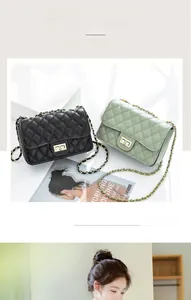 Close-up of quilted leather texture and golden metal chain strap on crossbody bag