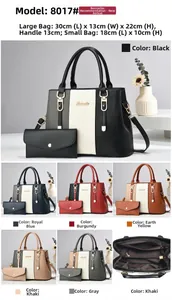 Detailed view of large embossed tote bag with matching pouch and golden metal logo