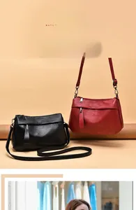Detail view of vintage soft leather crossbody bags in black and dark red finishes