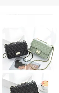 Detail of quilted diamond pattern chain crossbody bag with golden metal turn-lock
