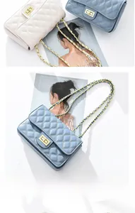Detail of quilted chain crossbody bag with gold-tone twist lock and dual color options
