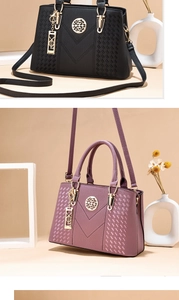 Detail of lychee pattern leather bags in black and plum with golden hardware accents