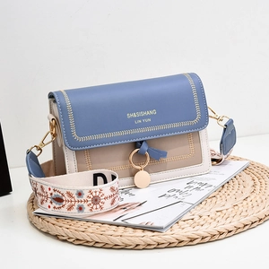 Contrast color PU leather crossbody bag with embroidered wide strap and gold hardware
