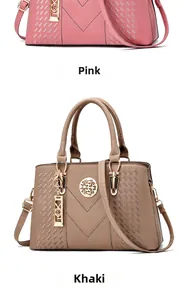 Detail of pink and khaki leather handbags with round metal logo and adjustable straps