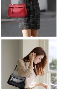 Detail of soft leather shoulder bags in black and red with detachable straps and zippers