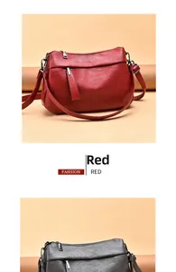 Detail of soft litchi grain PU leather texture and multi-zipper pockets on cross-body bag