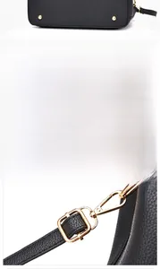 Detail of lychee pattern leather bag with golden bottom studs and adjustable strap