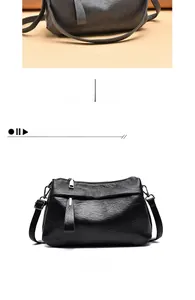 Detail of dark grey leather shoulder bag with fine pebble texture and silver hardware
