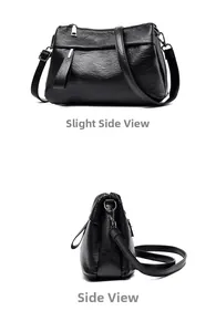 Detail view of black textured faux leather crossbody bag with multiple zippers and strap