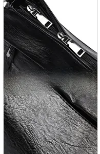 Detail of premium black lychee leather texture and dual silver metal zippers on bag